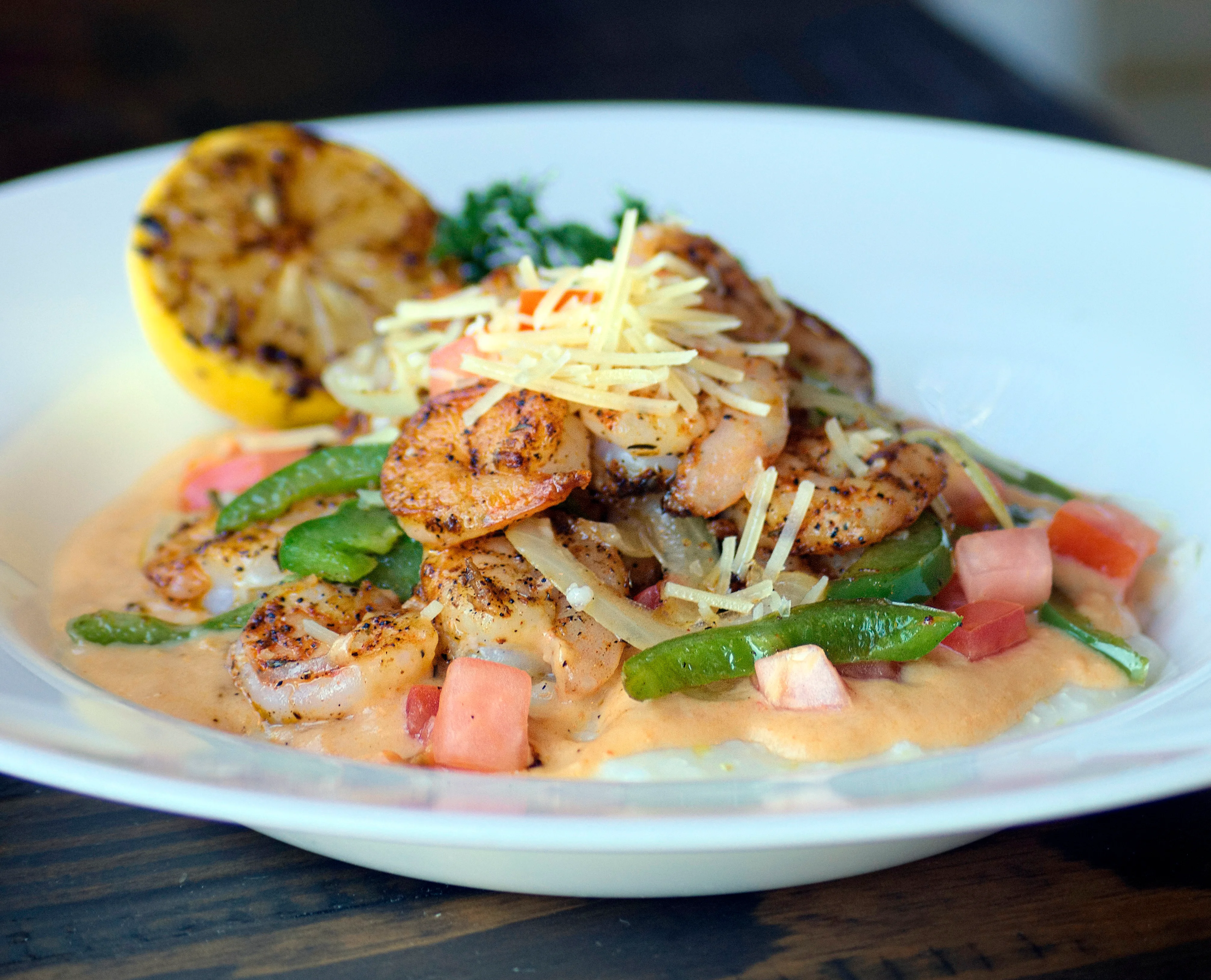 Spicy shrimp pasta in creamy sauce with grilled lemon