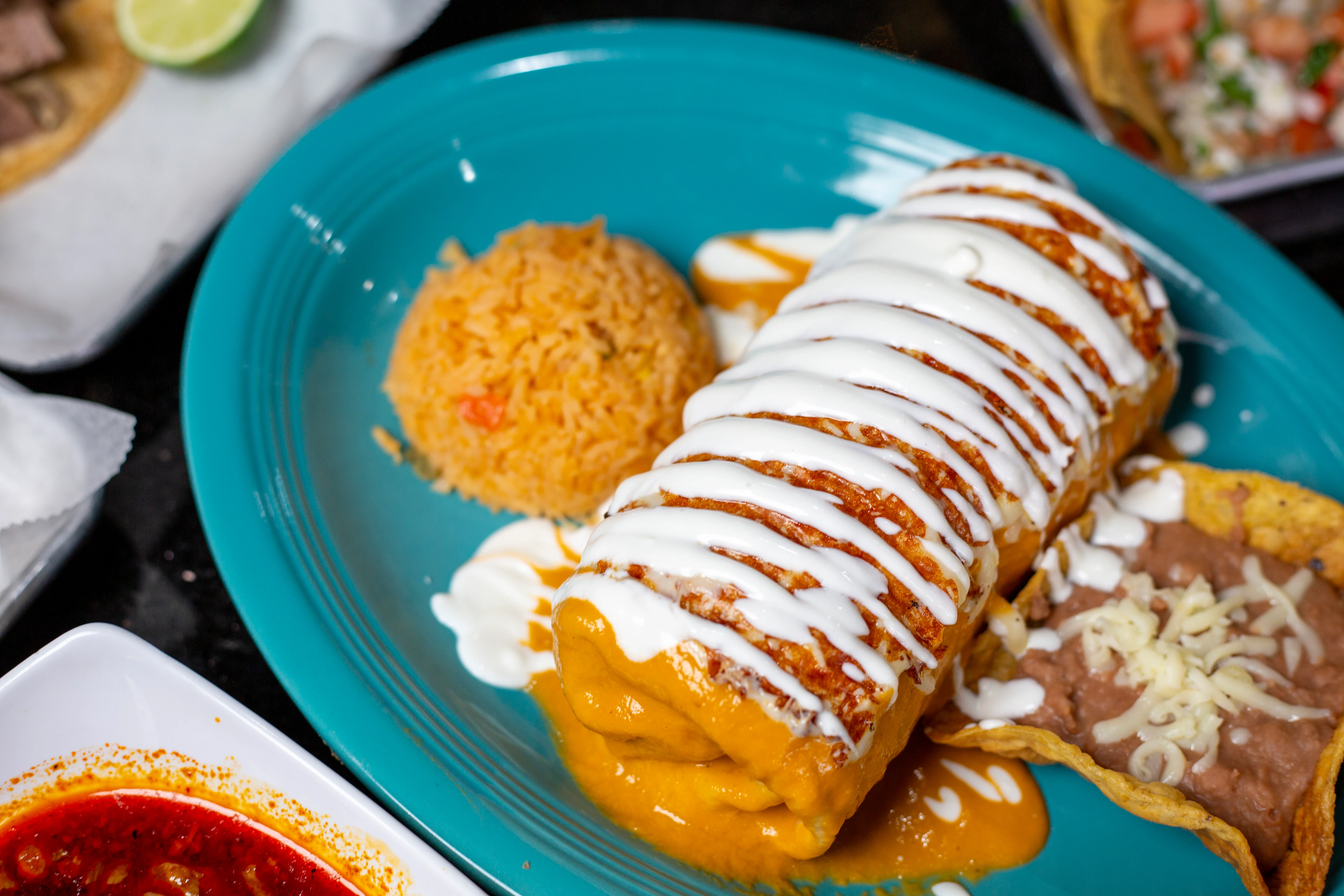 Delicious Mexican enchiladas topped with sour cream and served with rice