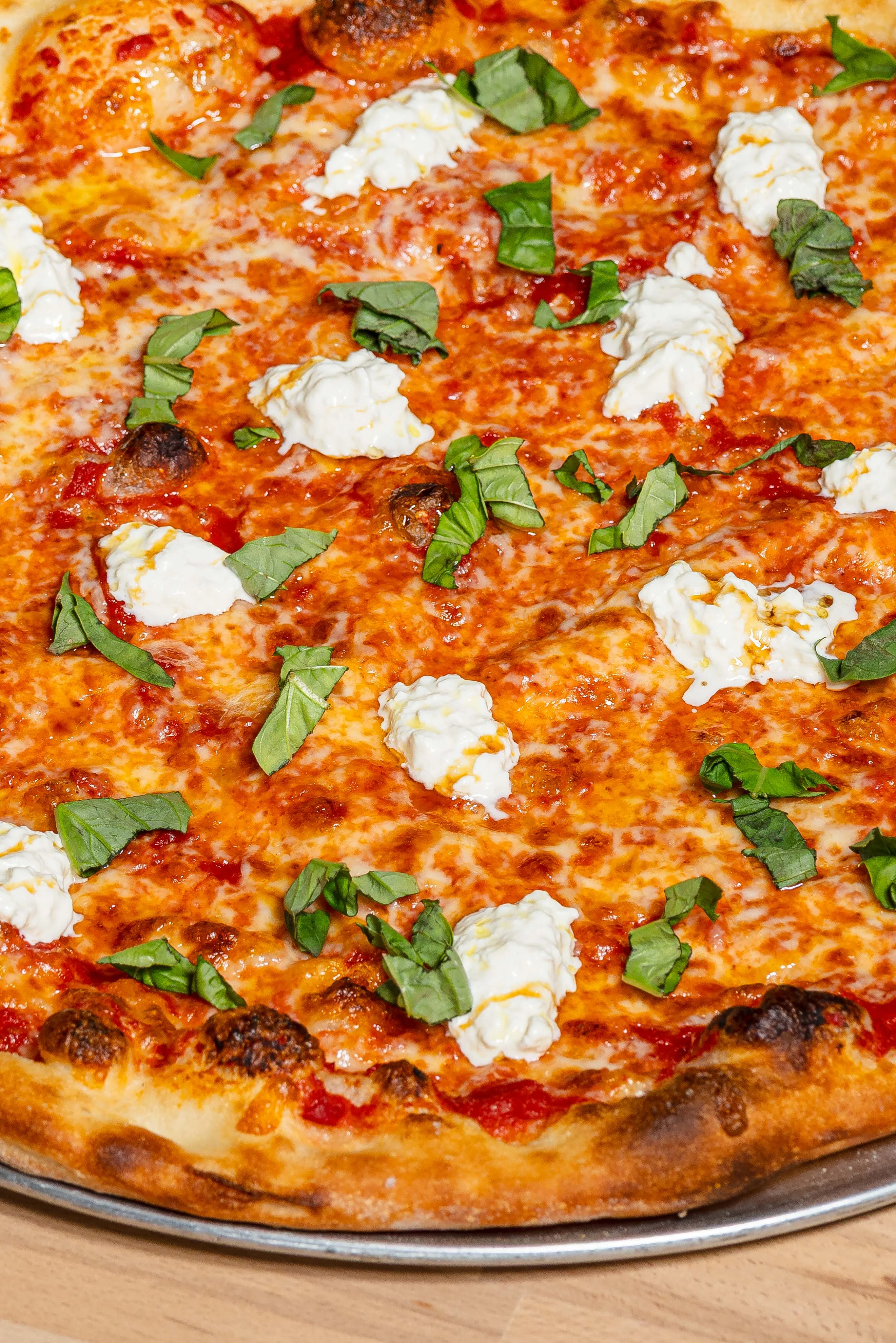 Delicious burrata pizza topped with fresh ingredients and herbs.
