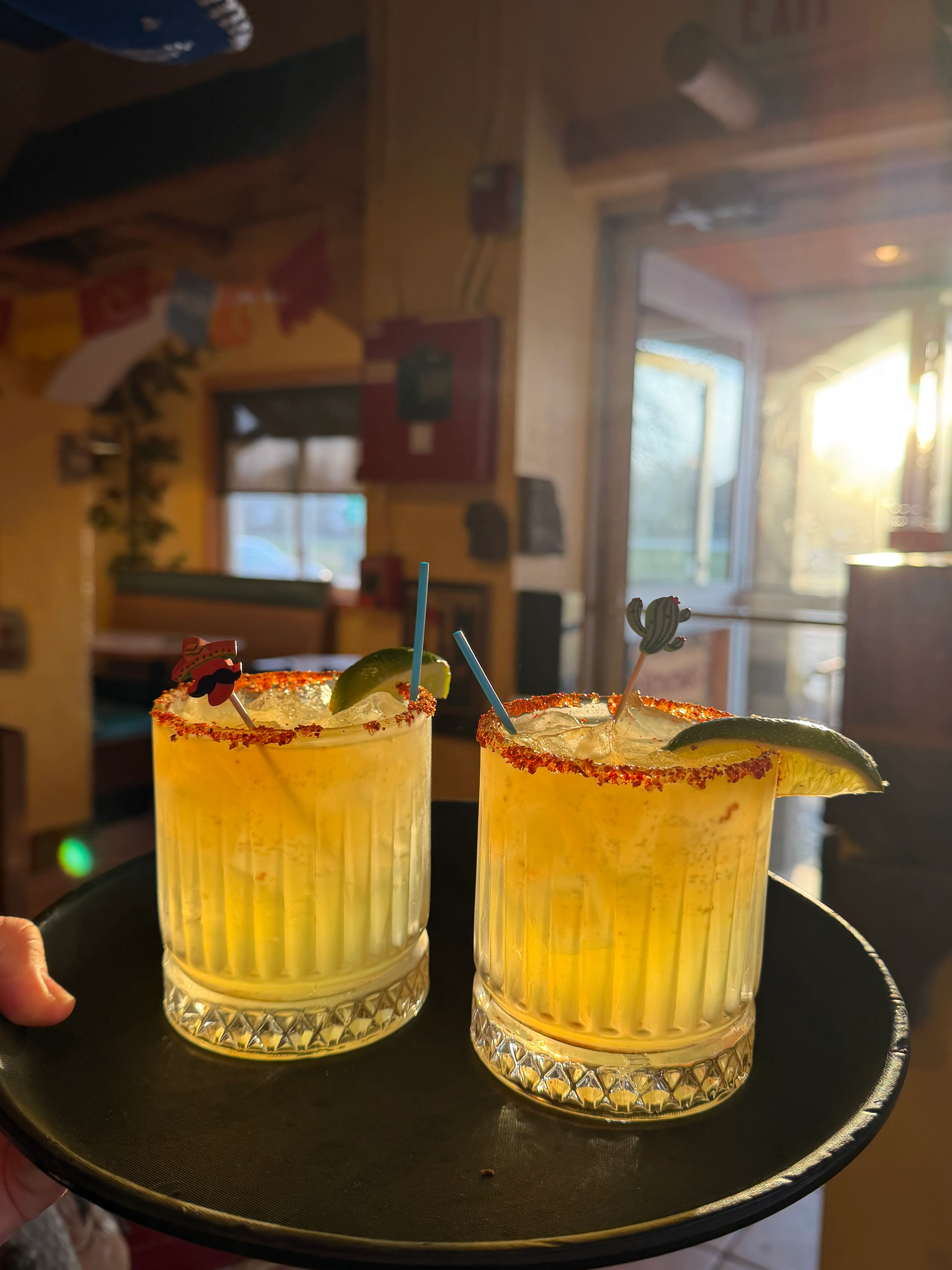 Refreshing margaritas served on a tray with vibrant garnishes