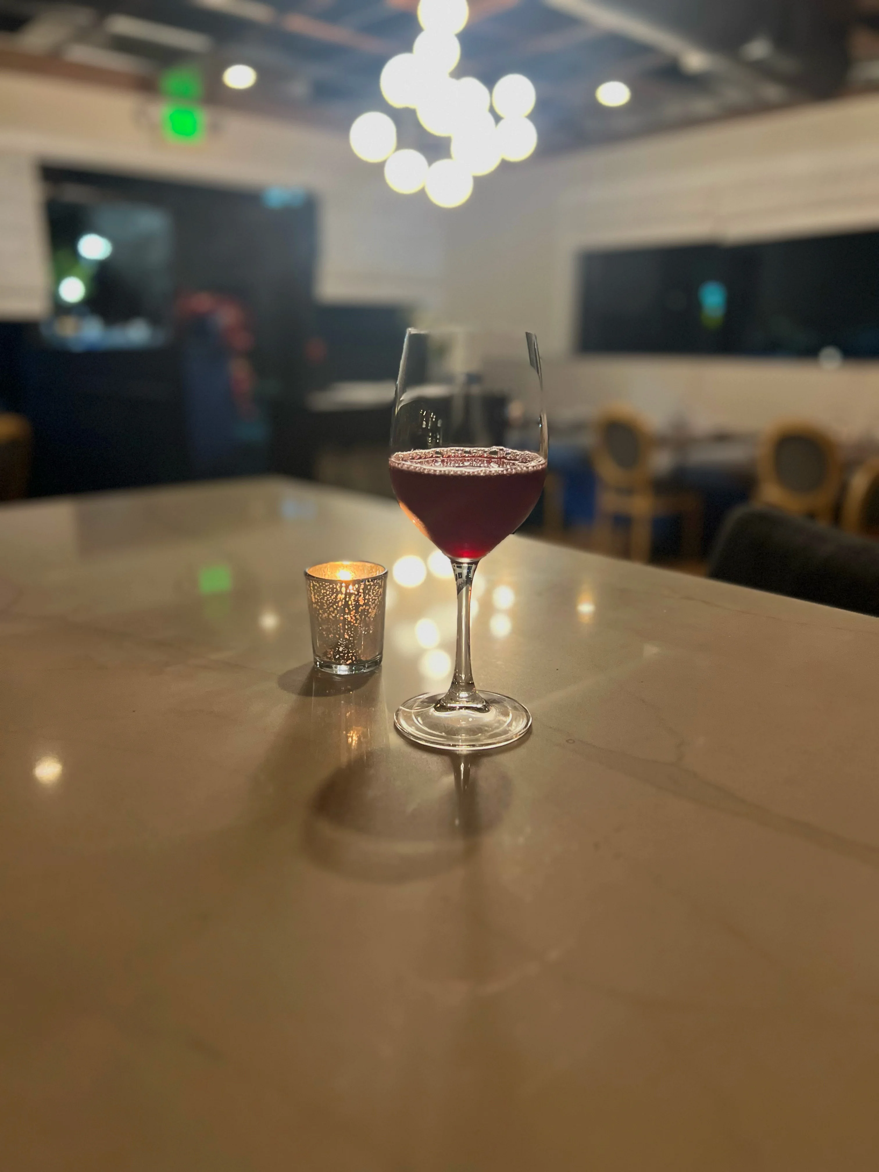 Elegant cocktail on a marble table in a cozy restaurant setting