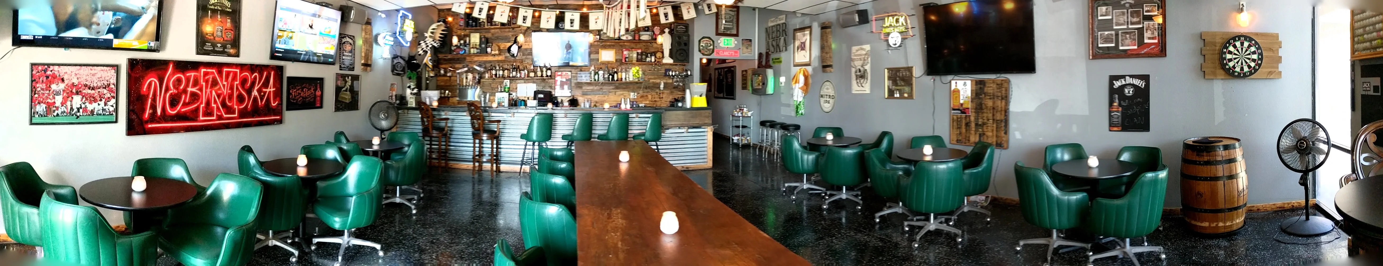 Cozy restaurant interior with green seating and rustic decor