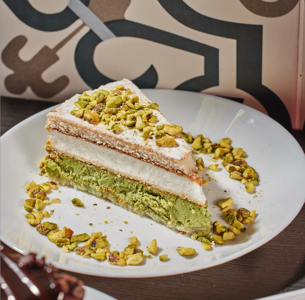Light and creamy ricotta cake layered with rich pistachio flavor and a smooth, velvety finish from Sufrat Grill.
