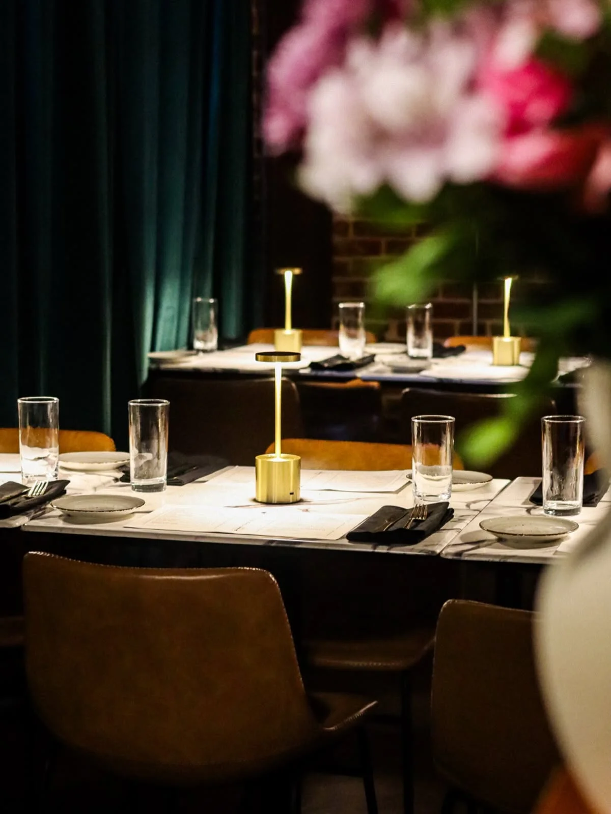 Elegant restaurant dining setup with salads and water glasses