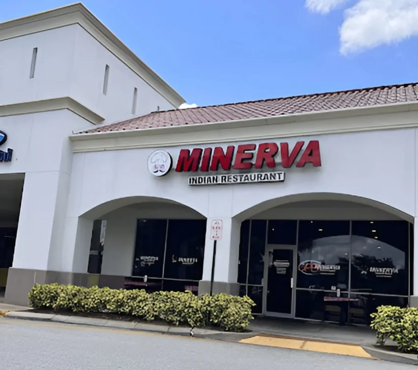 Exterior view of Minerva Indian Restaurant with signage