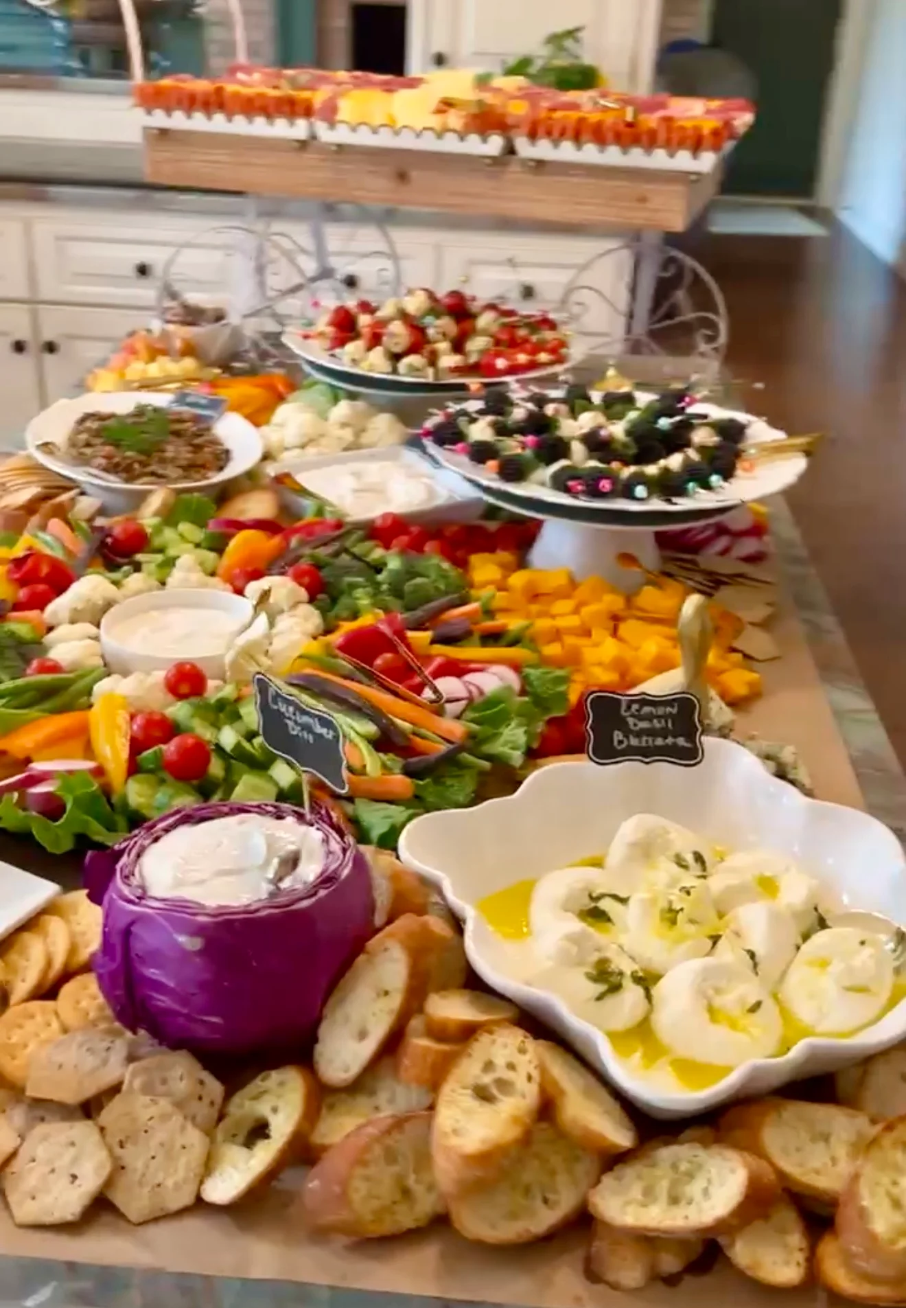 A vibrant spread of assorted appetizers and dips on a buffet table.