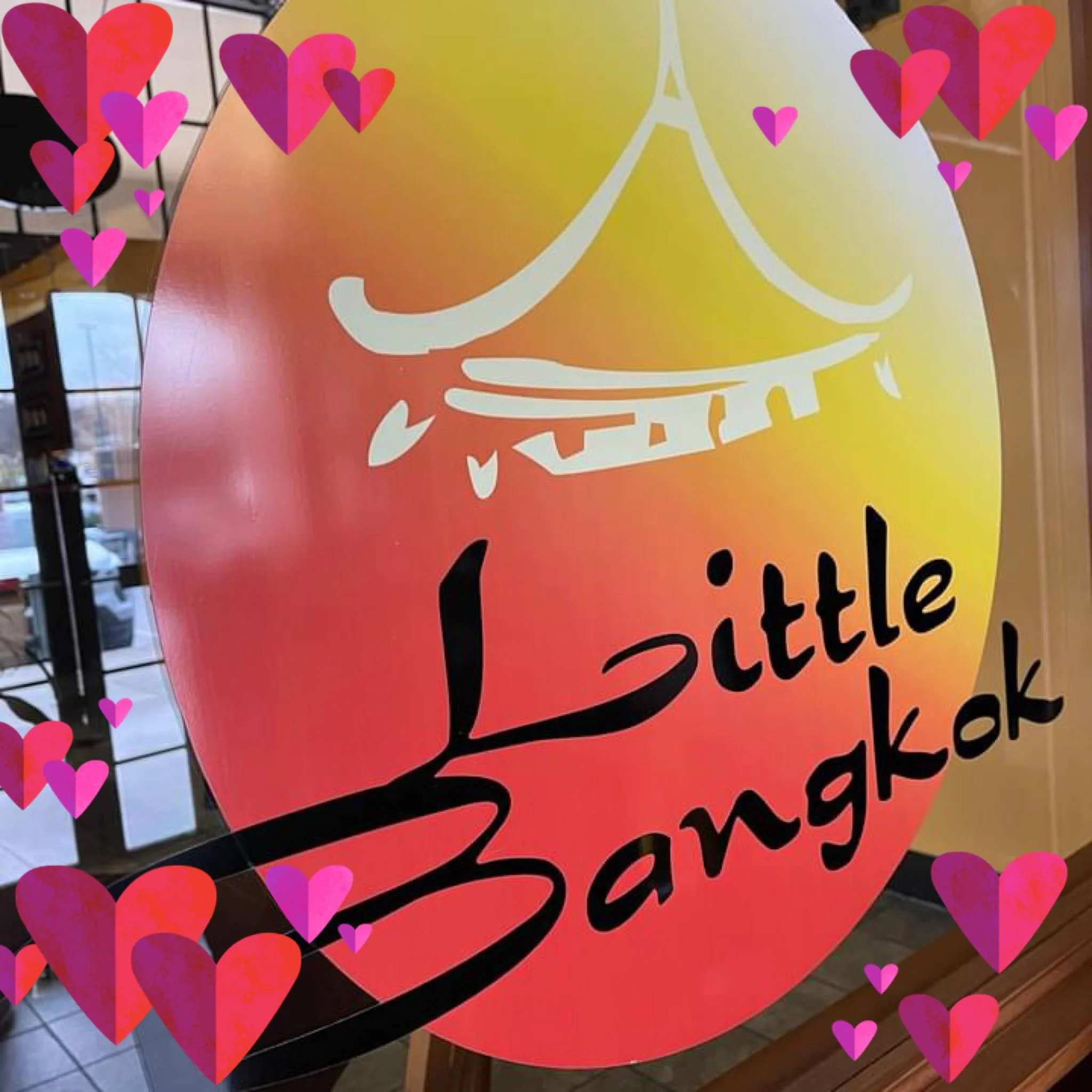 Signage for Little Bangkok restaurant with a warm gradient background