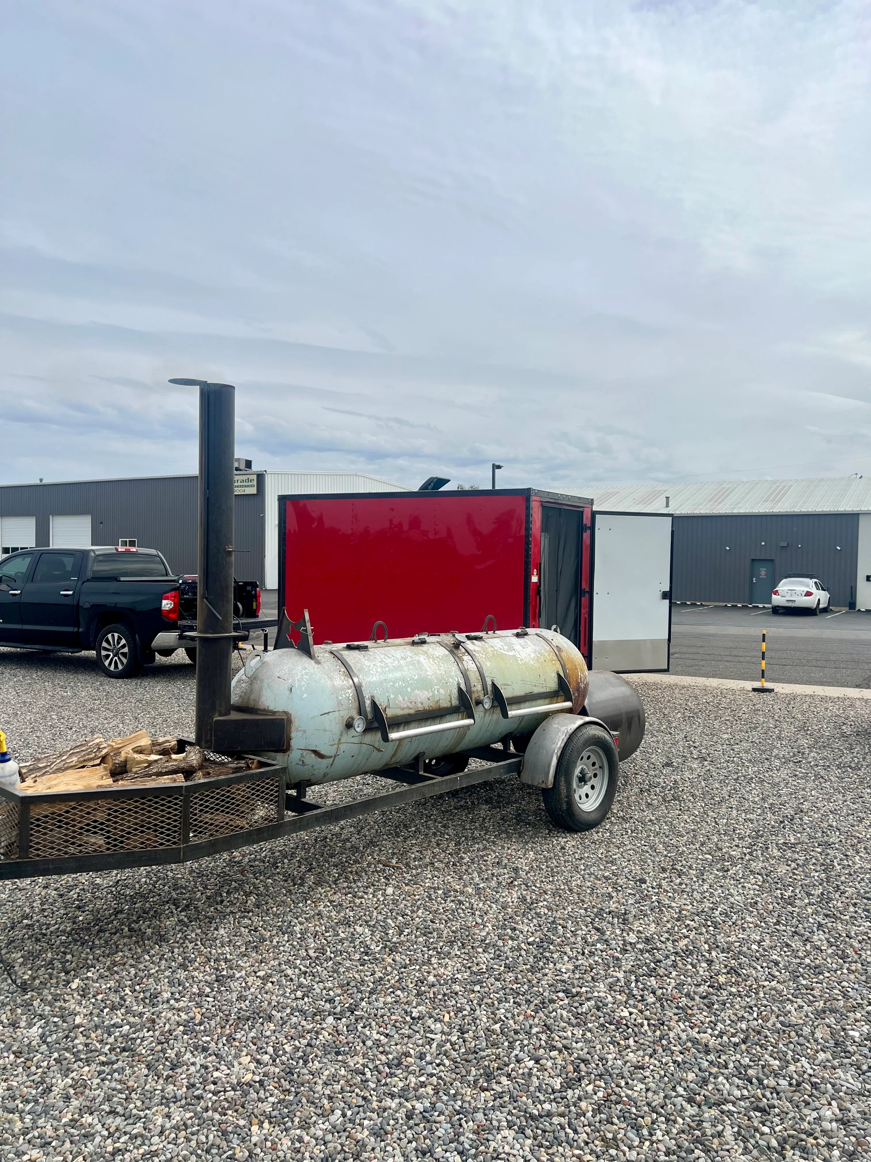 Mobile barbecue smoker trailer in a parking lot