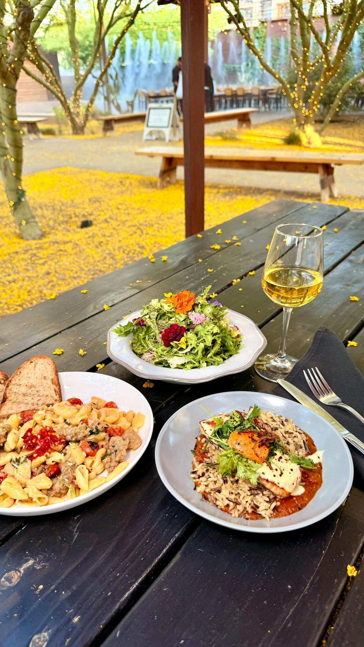 Artisan pasta dish with fresh herbs and a vibrant salad
