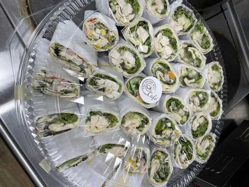 Fresh chicken wraps on a platter for catering