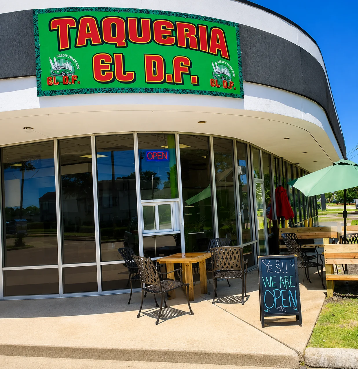 Exterior view of Taqueria El D.F. with open sign and outdoor seating