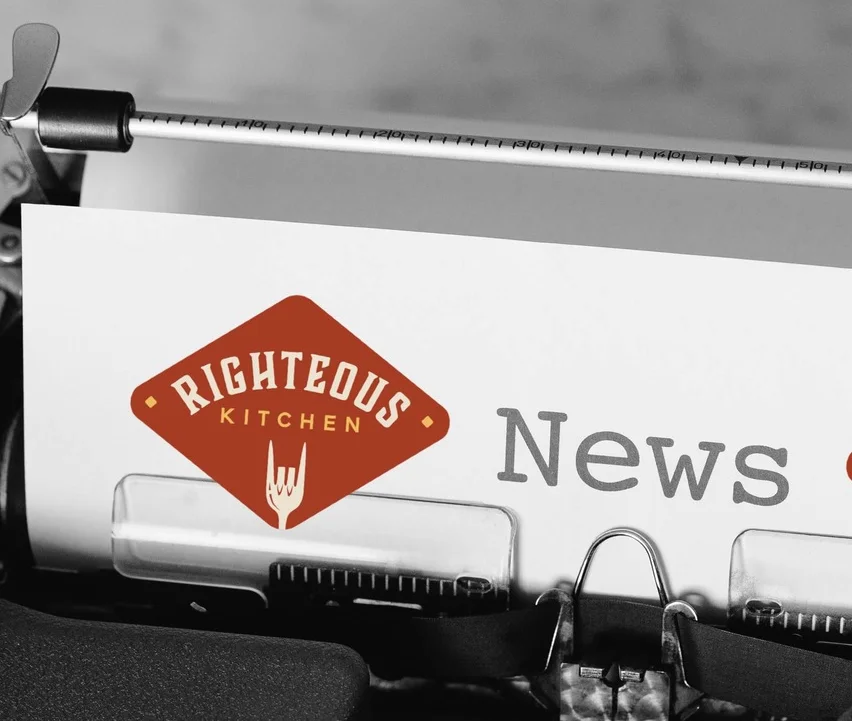 Typewriter with Righteous Kitchen news on paper