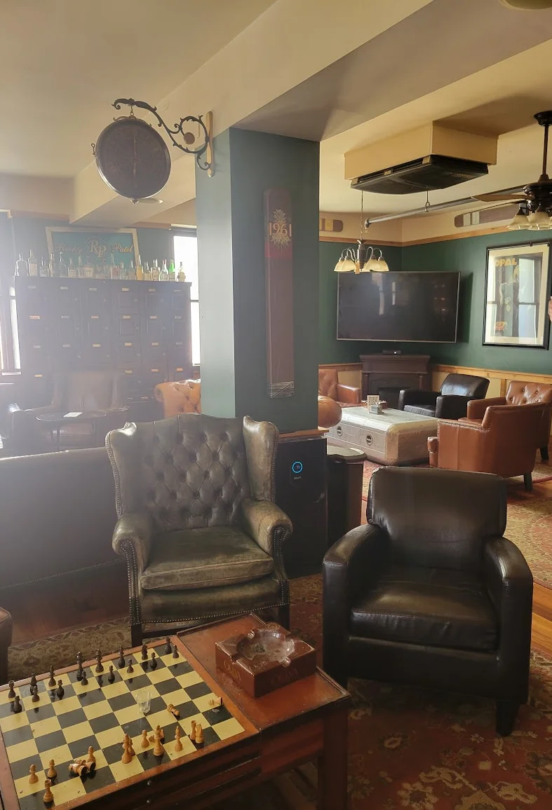 Cozy lounge area with chessboard and comfortable seating.