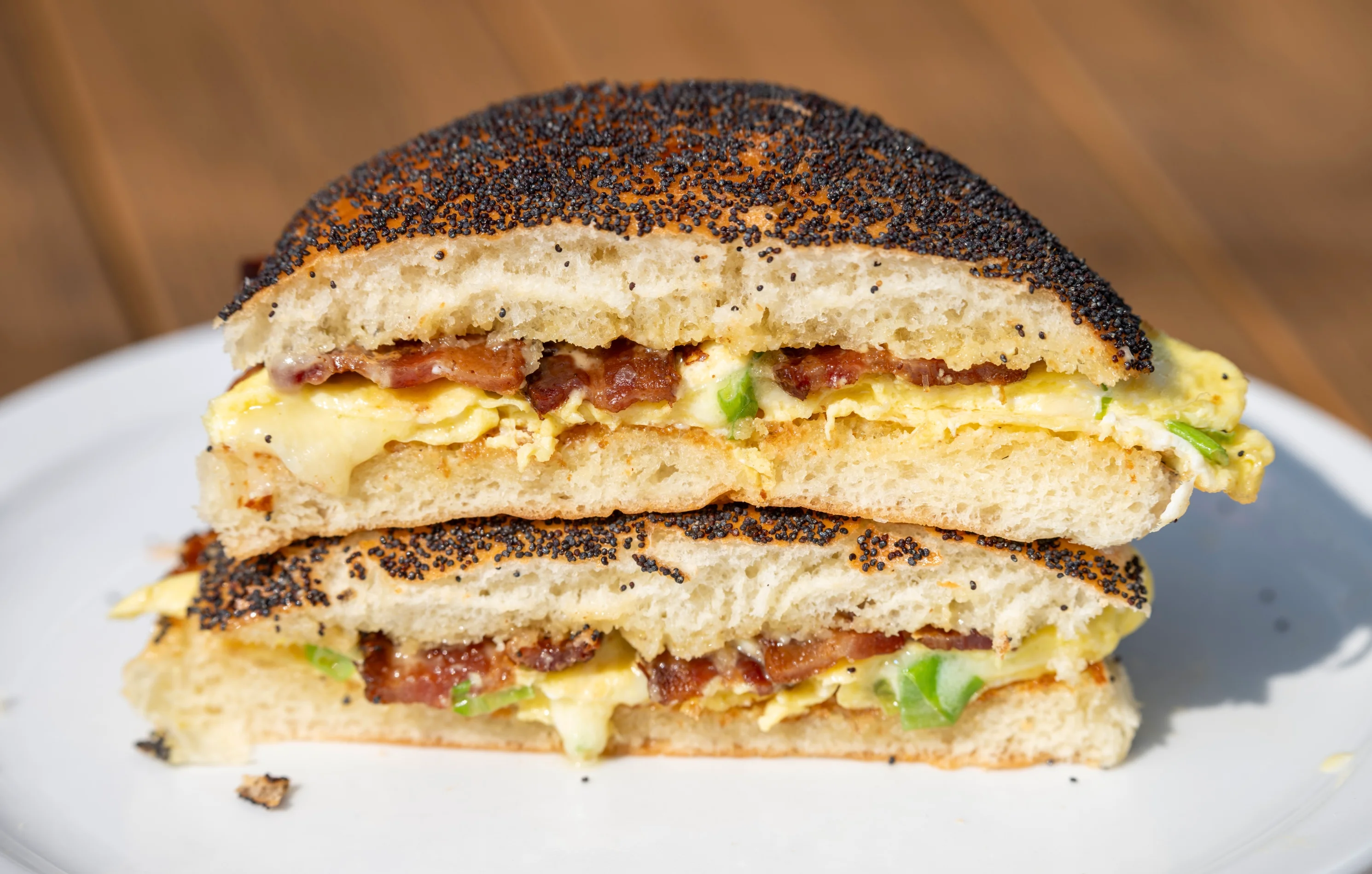 Our Breakfast Sandwich — Your choice of Bacon or Avocado, scrambled-folded egg with scallions, white cheddar, chipotle mayo or Joezauce, on a homemade poppy seed roll.