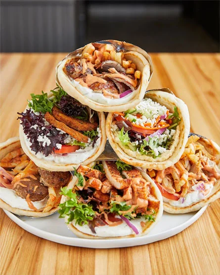 Assorted Mediterranean wraps with grilled meats and fresh vegetables