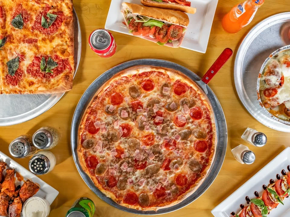 Delicious pepperoni and sausage pizza on a wooden table