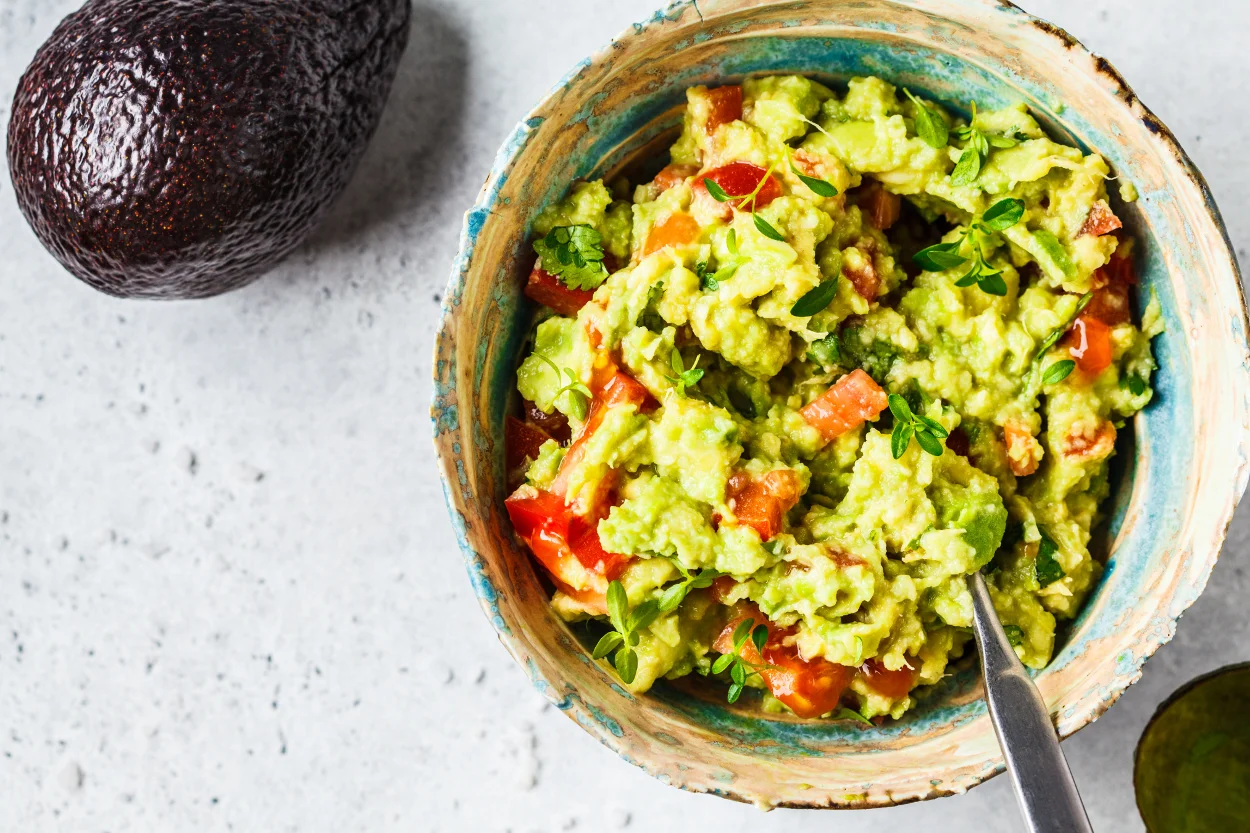 Fresh guacamole served in a colorful bowl