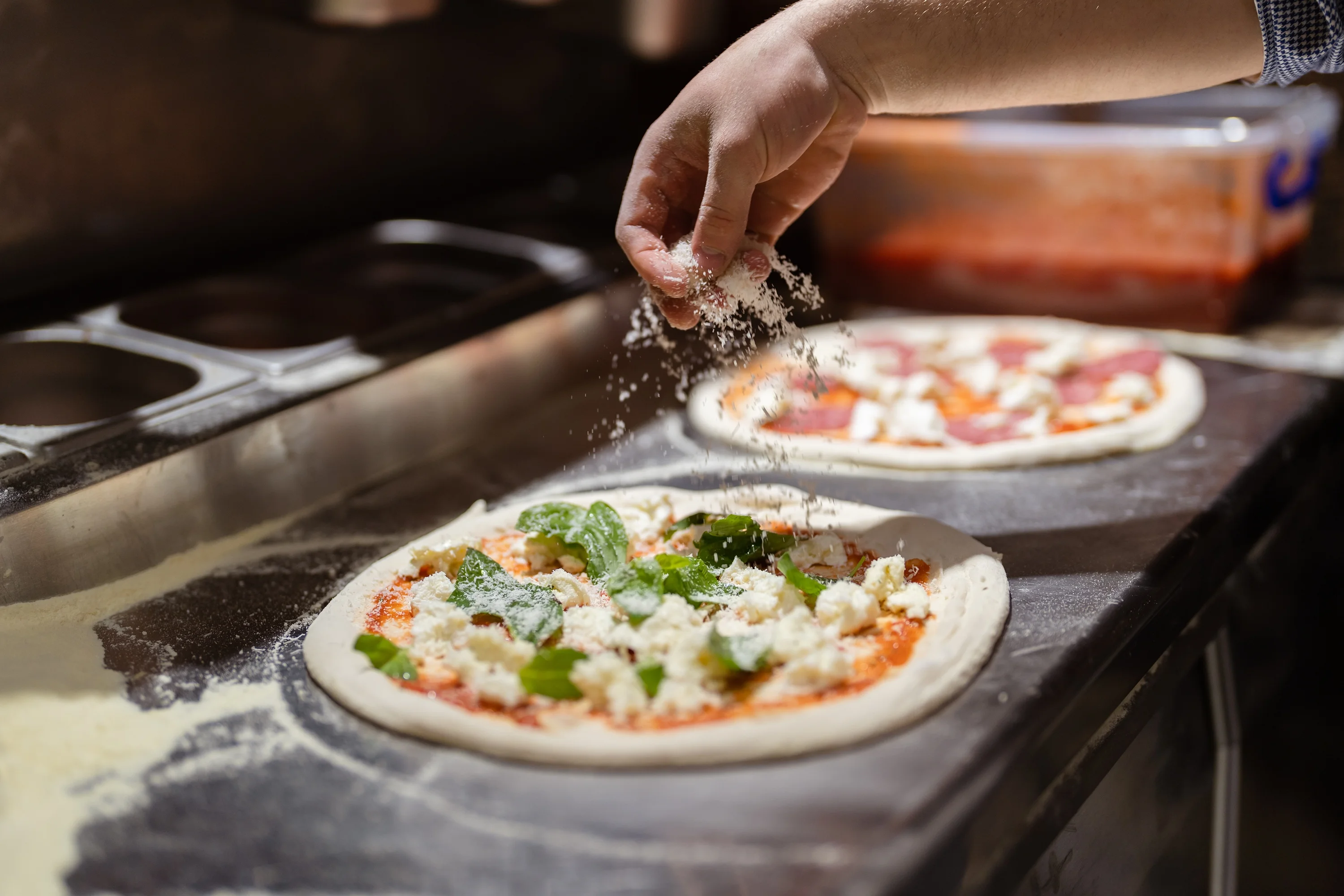 Pizza chief preparing wood fired pizza