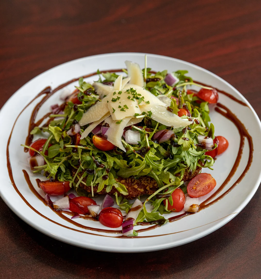 Fresh arugula salad with cherry tomatoes and shaved cheese