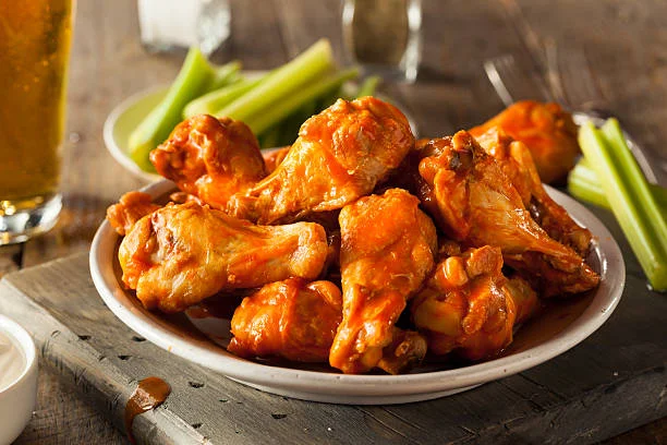 Spicy buffalo chicken wings served with celery sticks