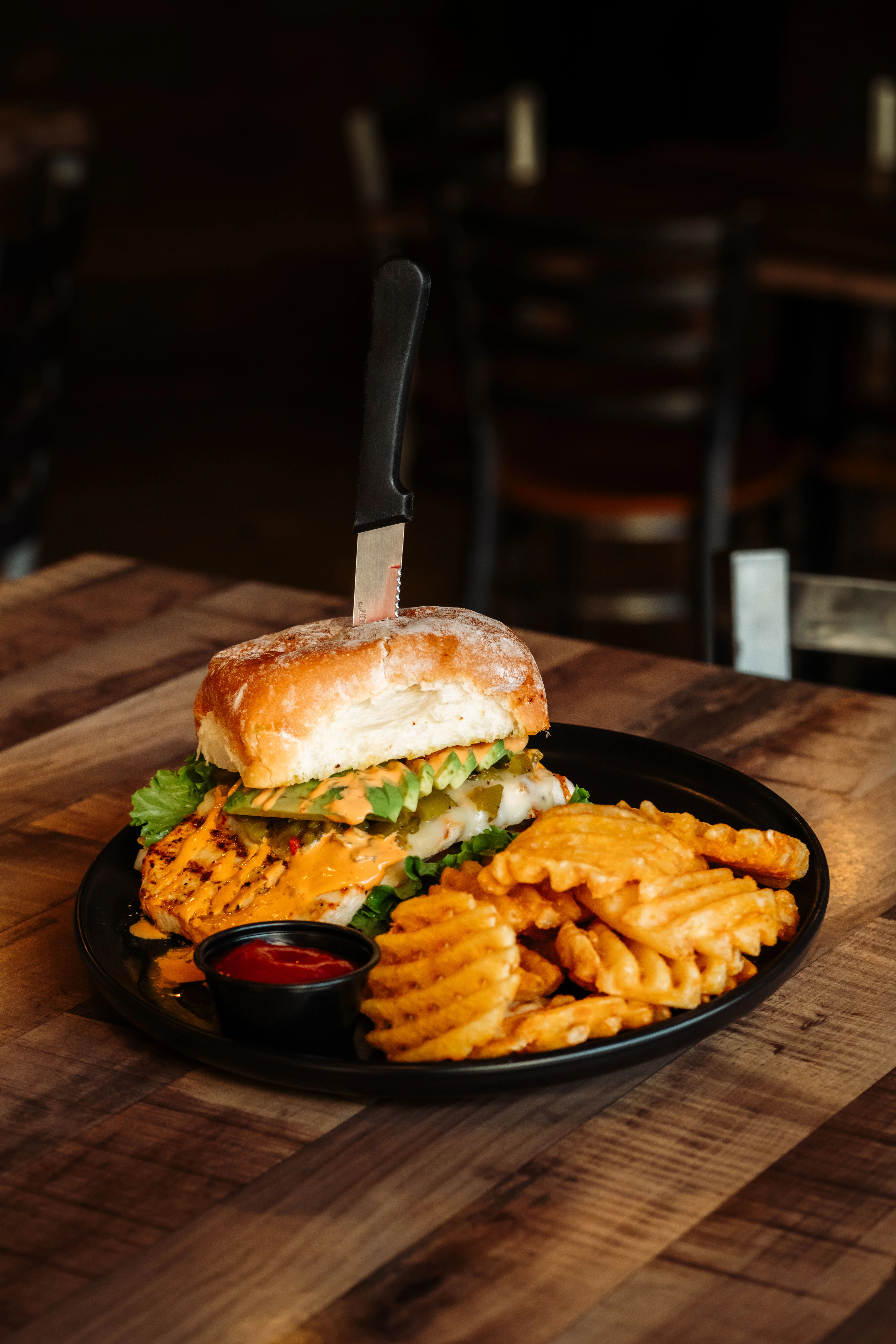 Delicious gourmet burger with fresh toppings on a wooden table
