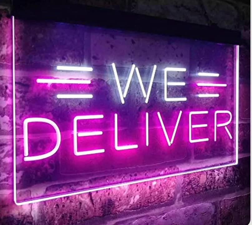 Neon sign reading 'We Deliver' in vibrant colors