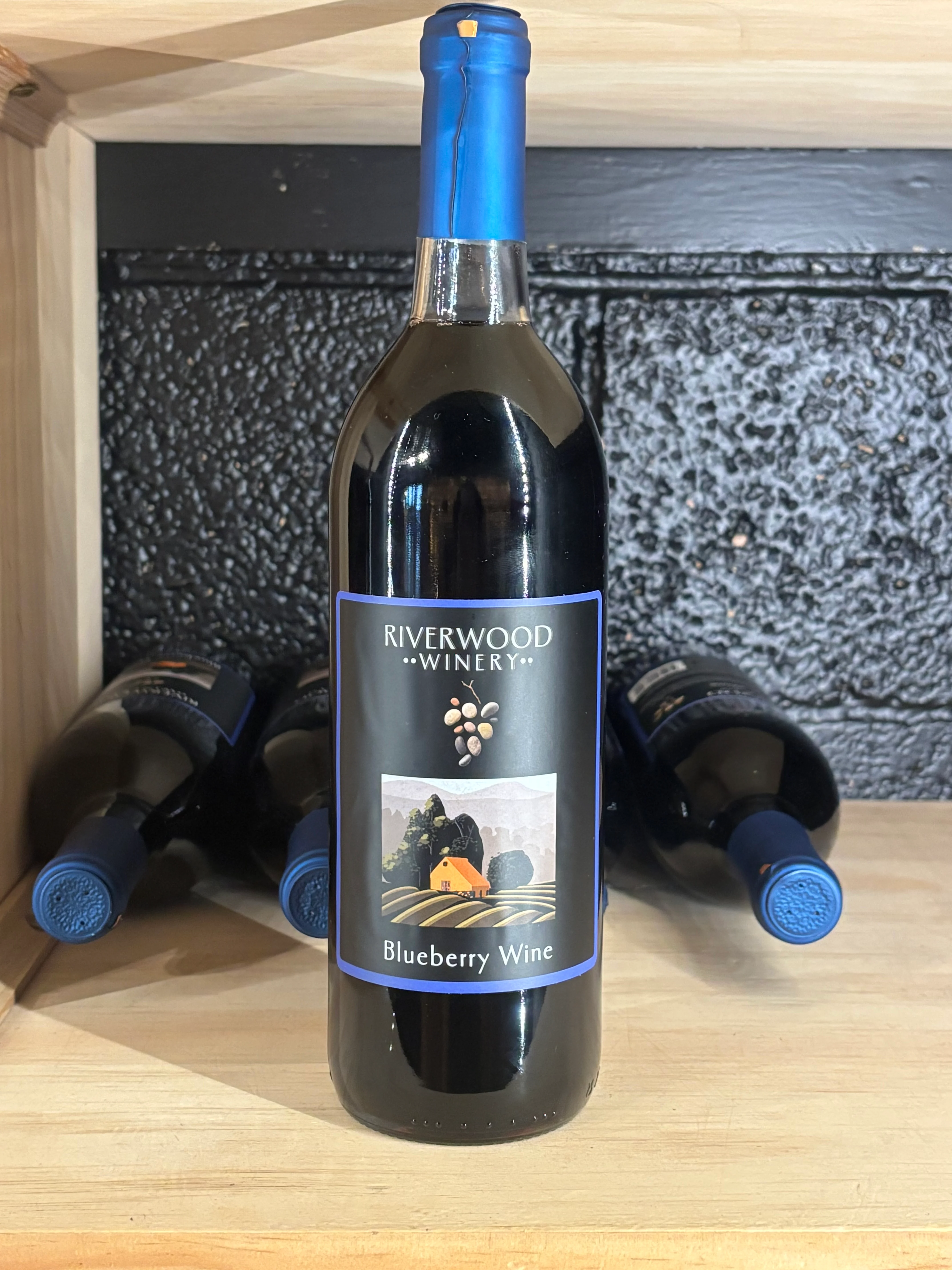 Bottle of Riverwood Blueberry Wine on display