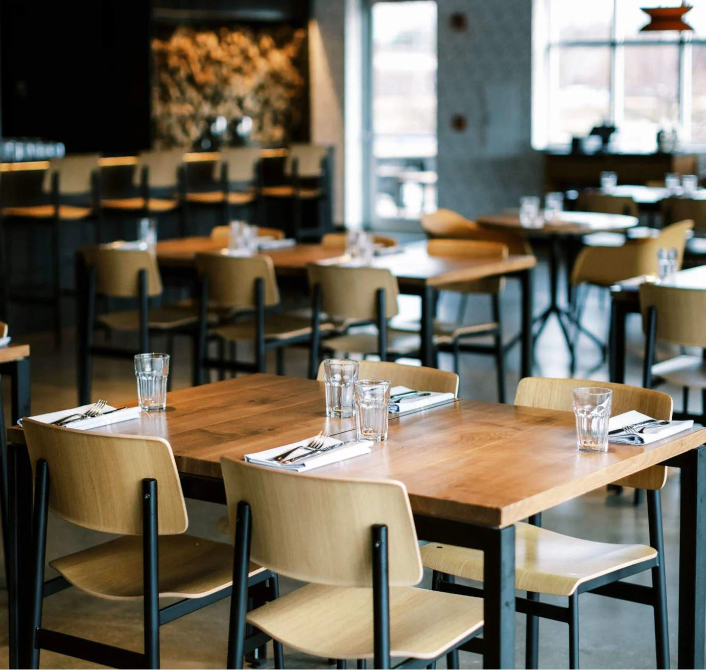 Modern restaurant interior with wooden tables and chairs