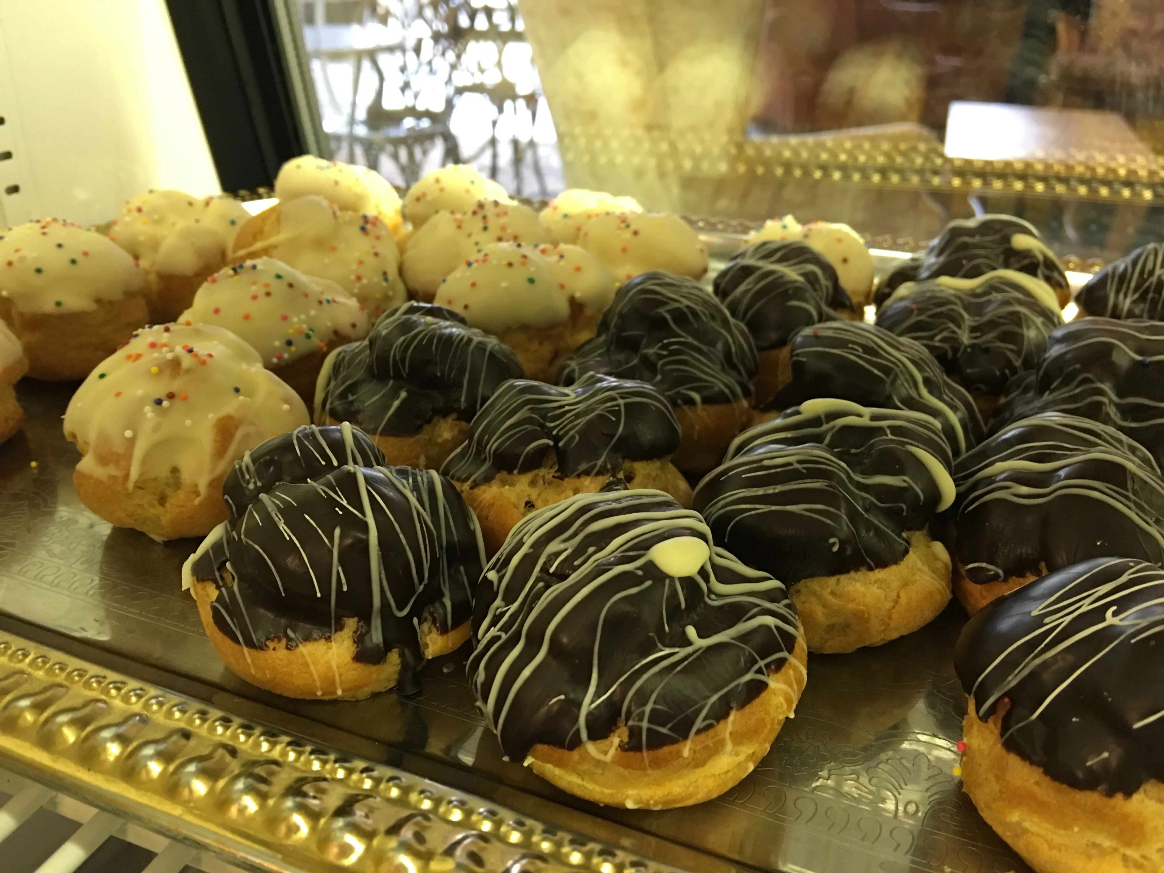 Assorted cream-filled pastries with chocolate and white icing