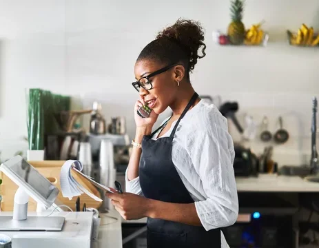 Barista on the phone in a cozy café setting