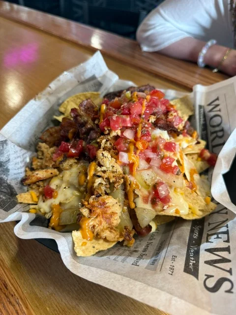 Loaded nachos topped with chicken and bacon