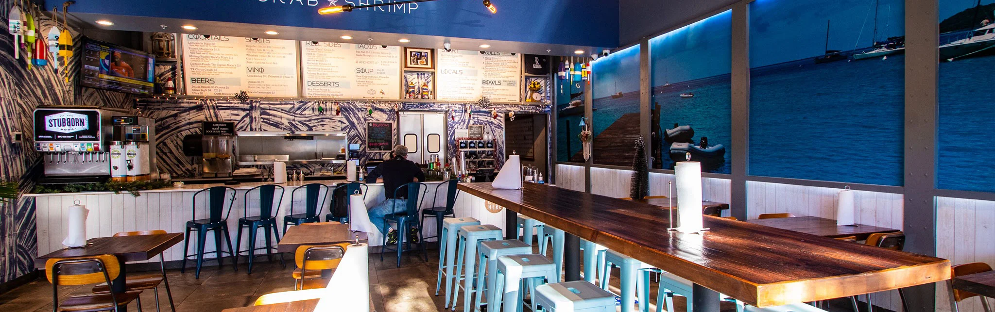 Cozy restaurant interior with nautical decor and bar seating