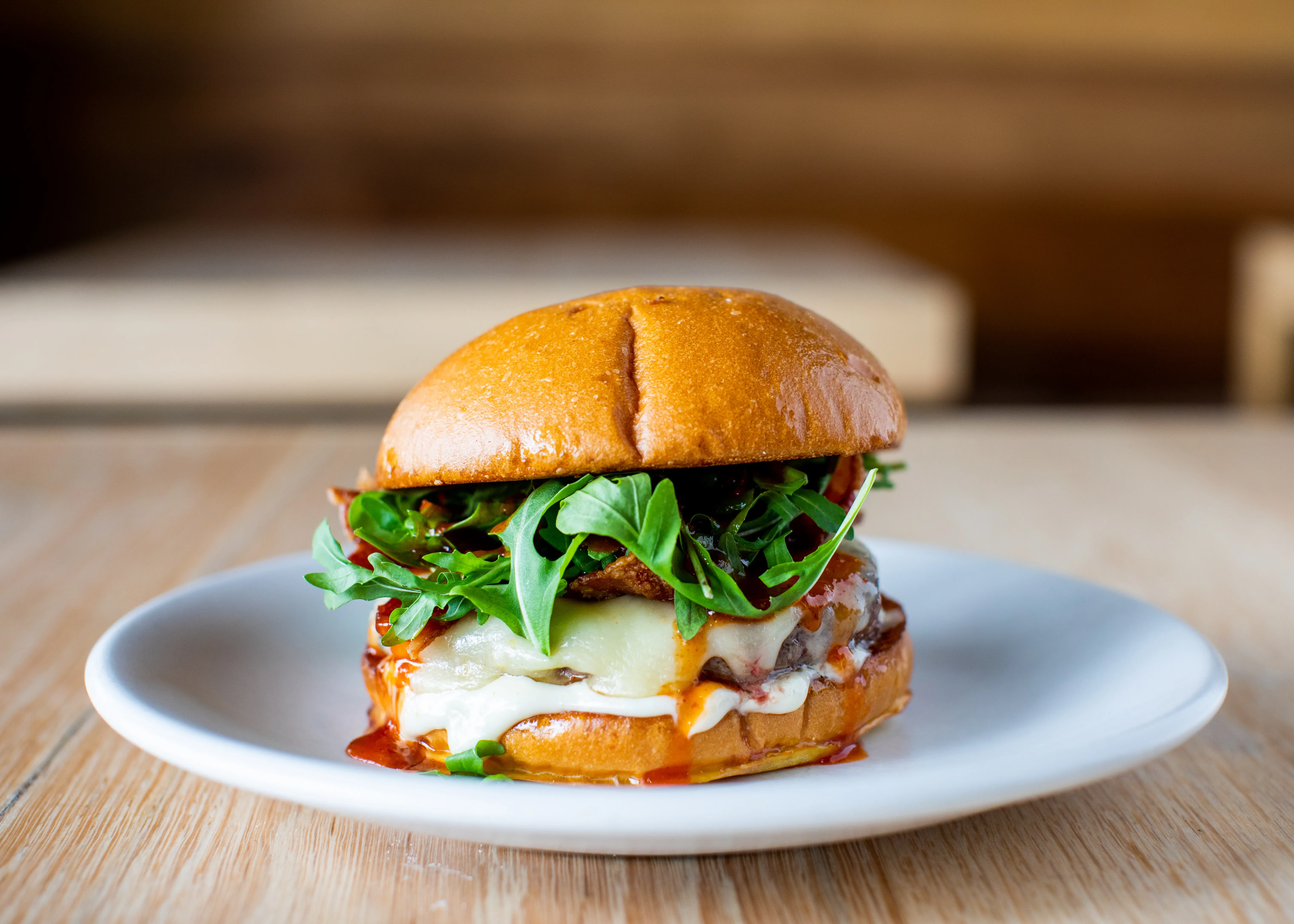 Gourmet burger with arugula and melted cheese