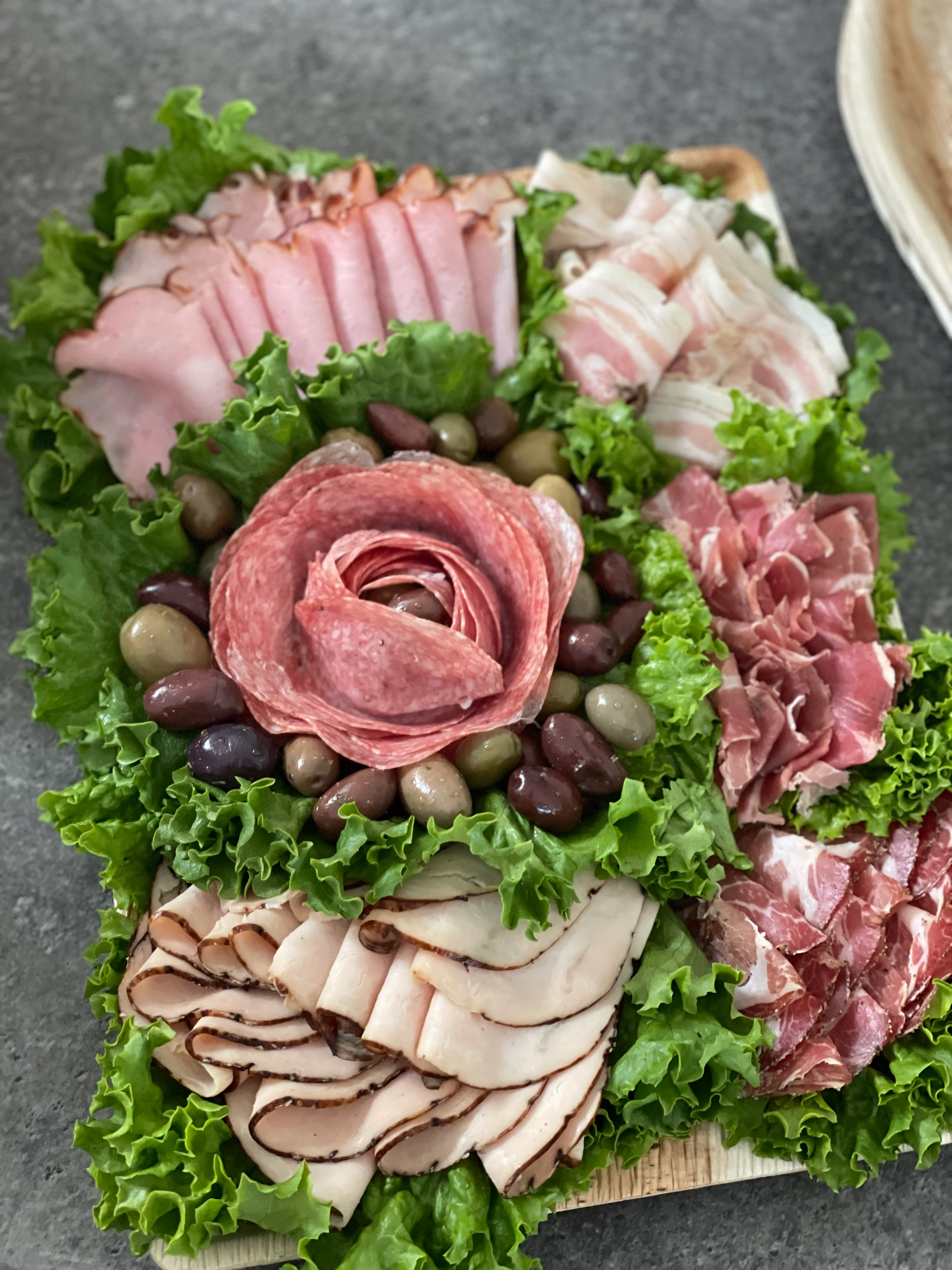 Italian charcuterie board with assorted meats and olives