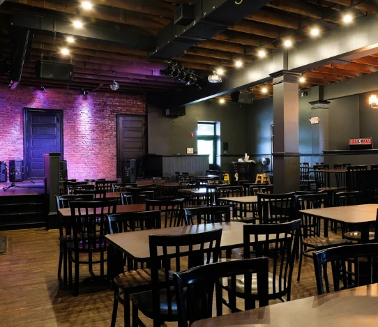 Cozy restaurant interior with warm lighting and wooden beams