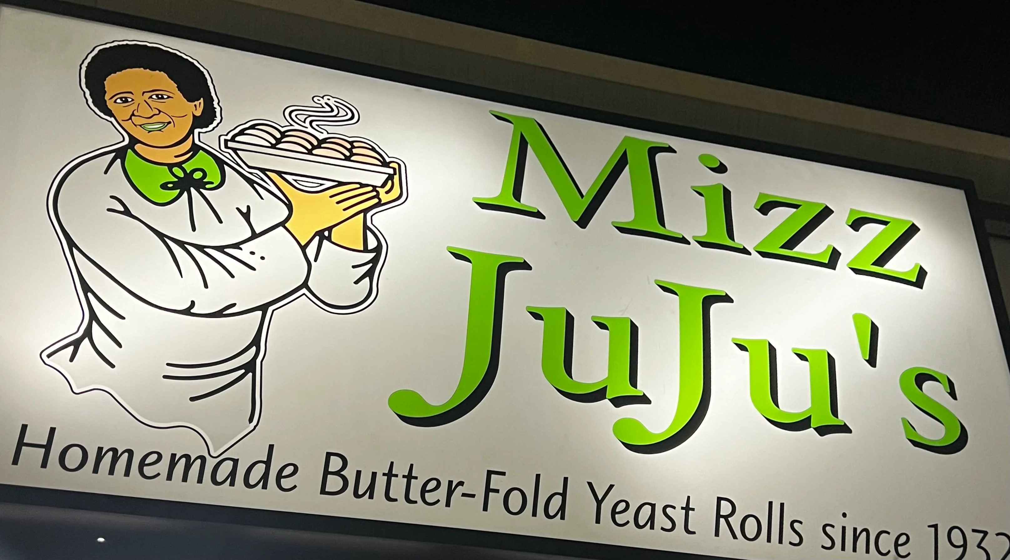 Sign for Mizz JuJu's featuring homemade butter-fold yeast rolls