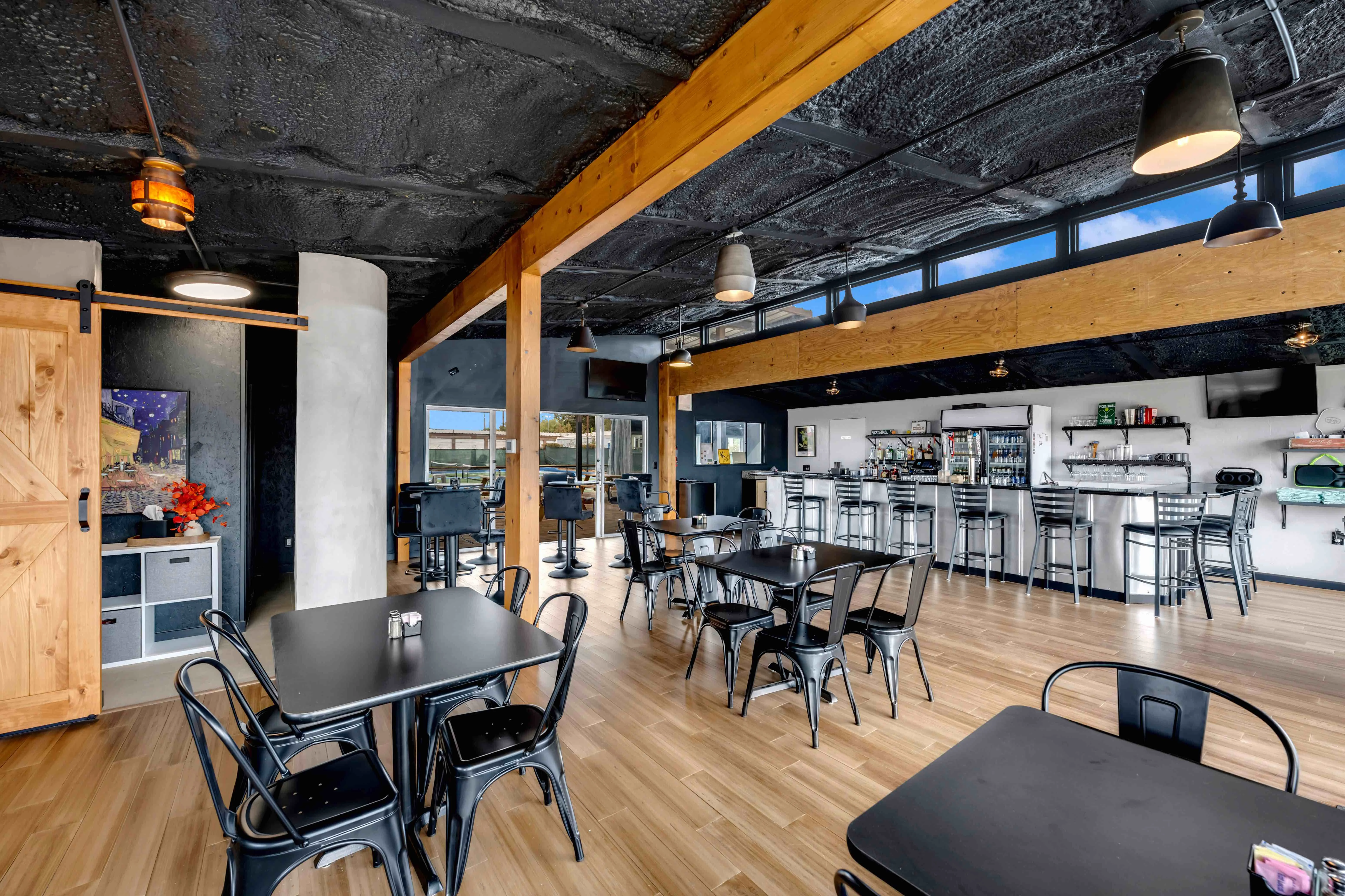 Modern restaurant interior with wooden beams and stylish seating