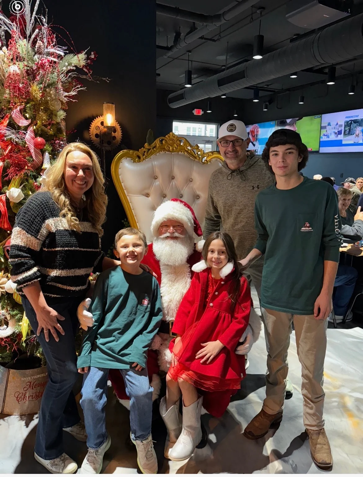 Family photo with Santa Claus in a festive restaurant setting