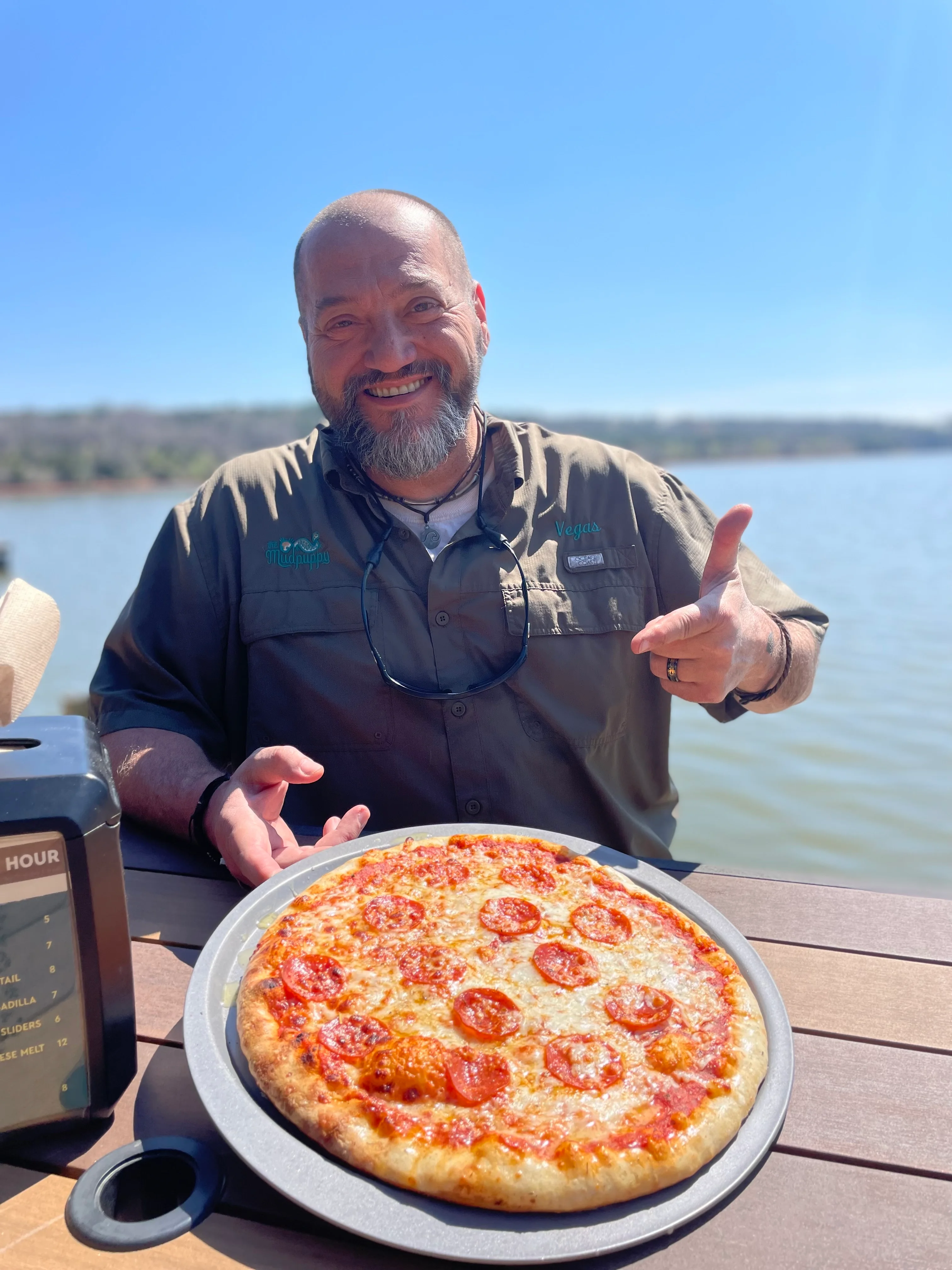 Pepperoni pizza served by the lake