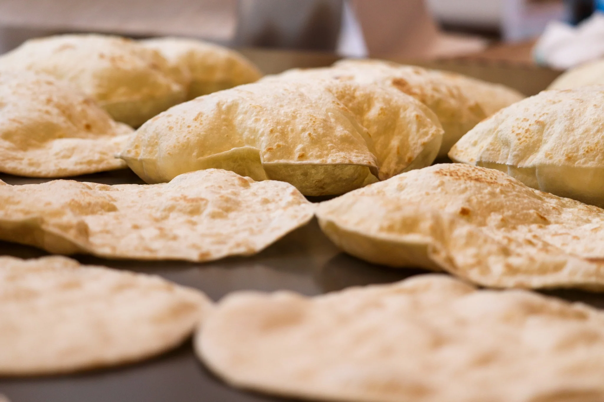 Freshly baked Indian naan bread on a griddle