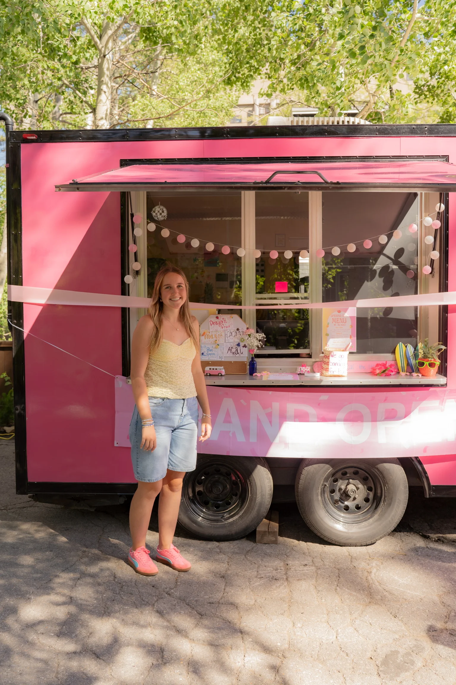 Food truck with a pink exterior and cheerful decor