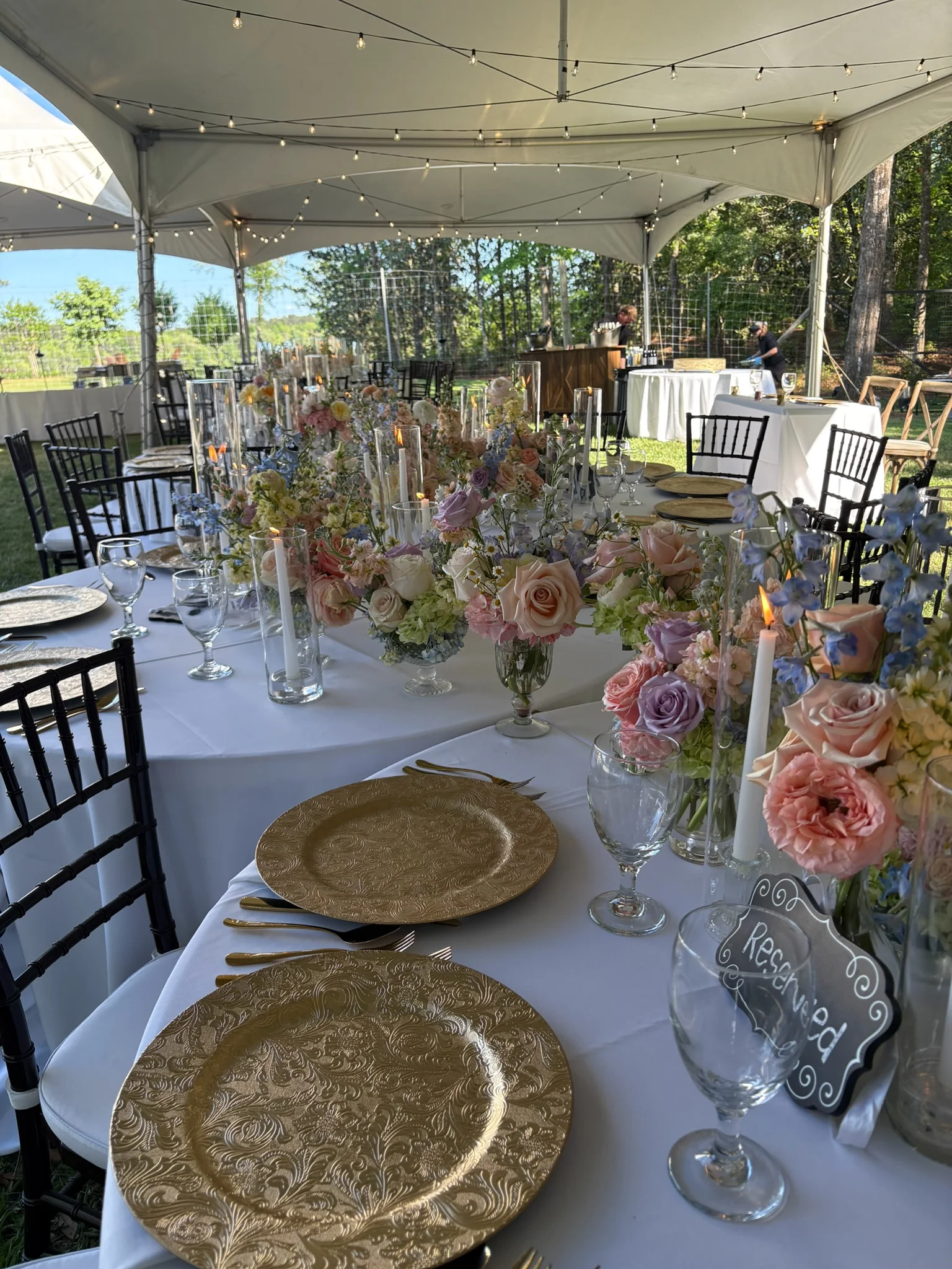 Elegant outdoor dining setup with floral centerpieces