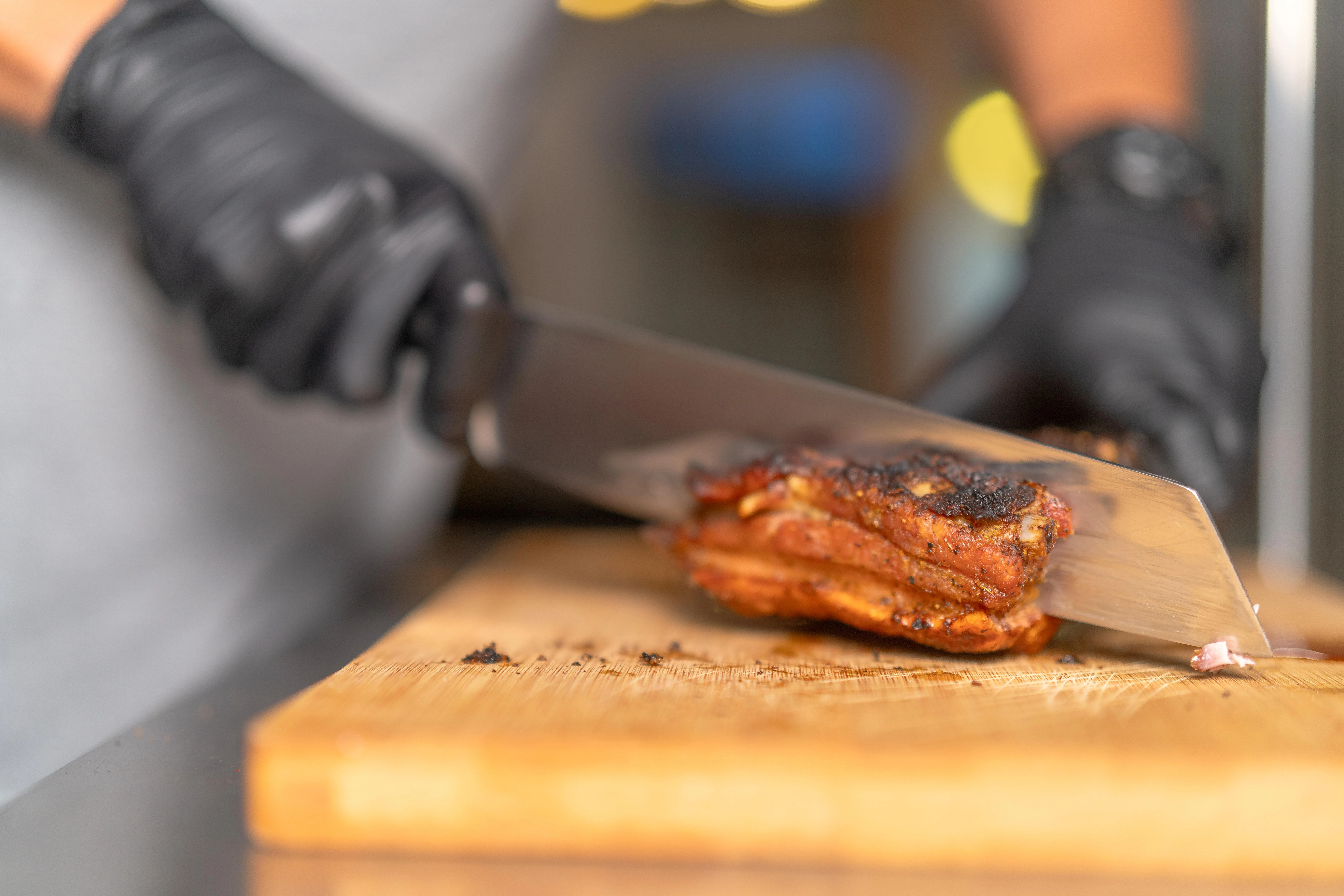 Slicing smoked brisket on a wooden cutting board