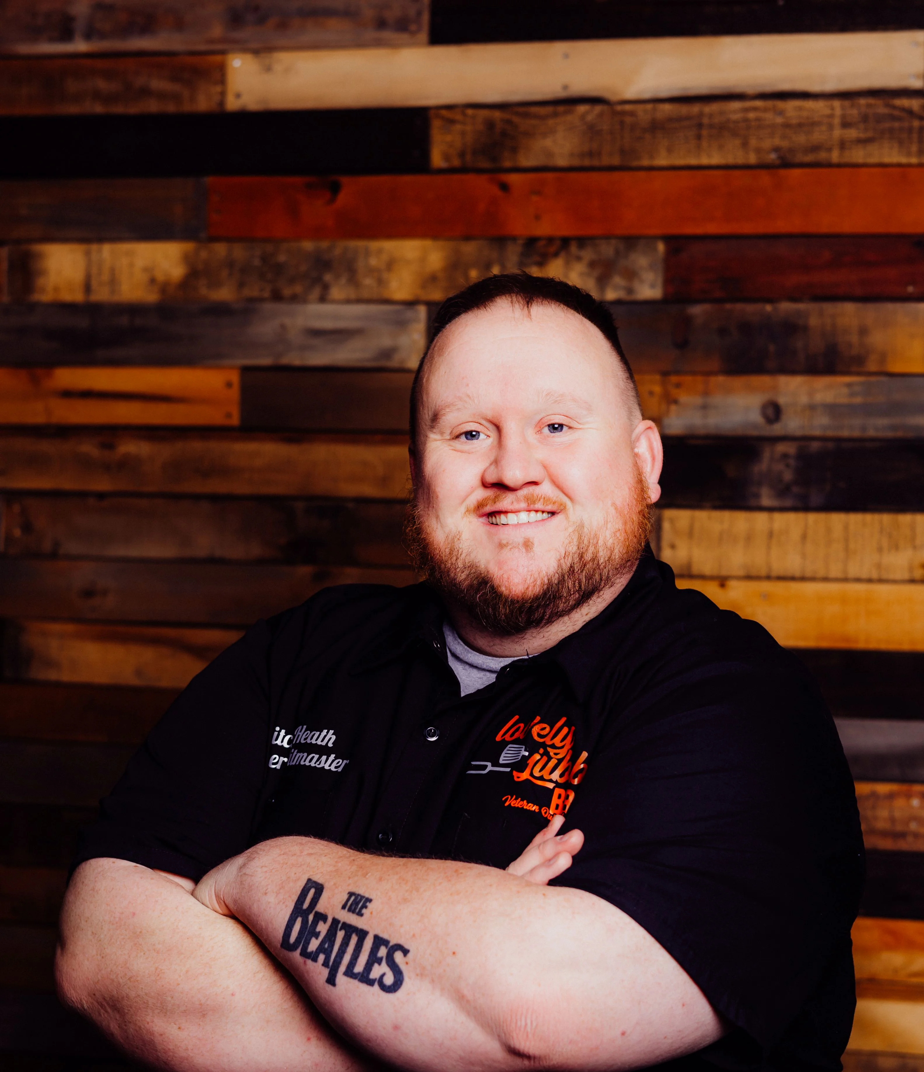 Chef posing confidently in a rustic restaurant setting