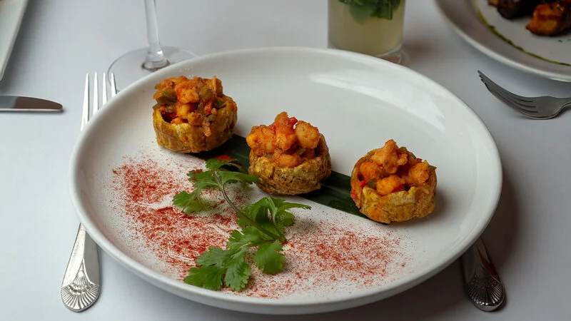 Crispy shrimp-filled Indian puris on a white plate