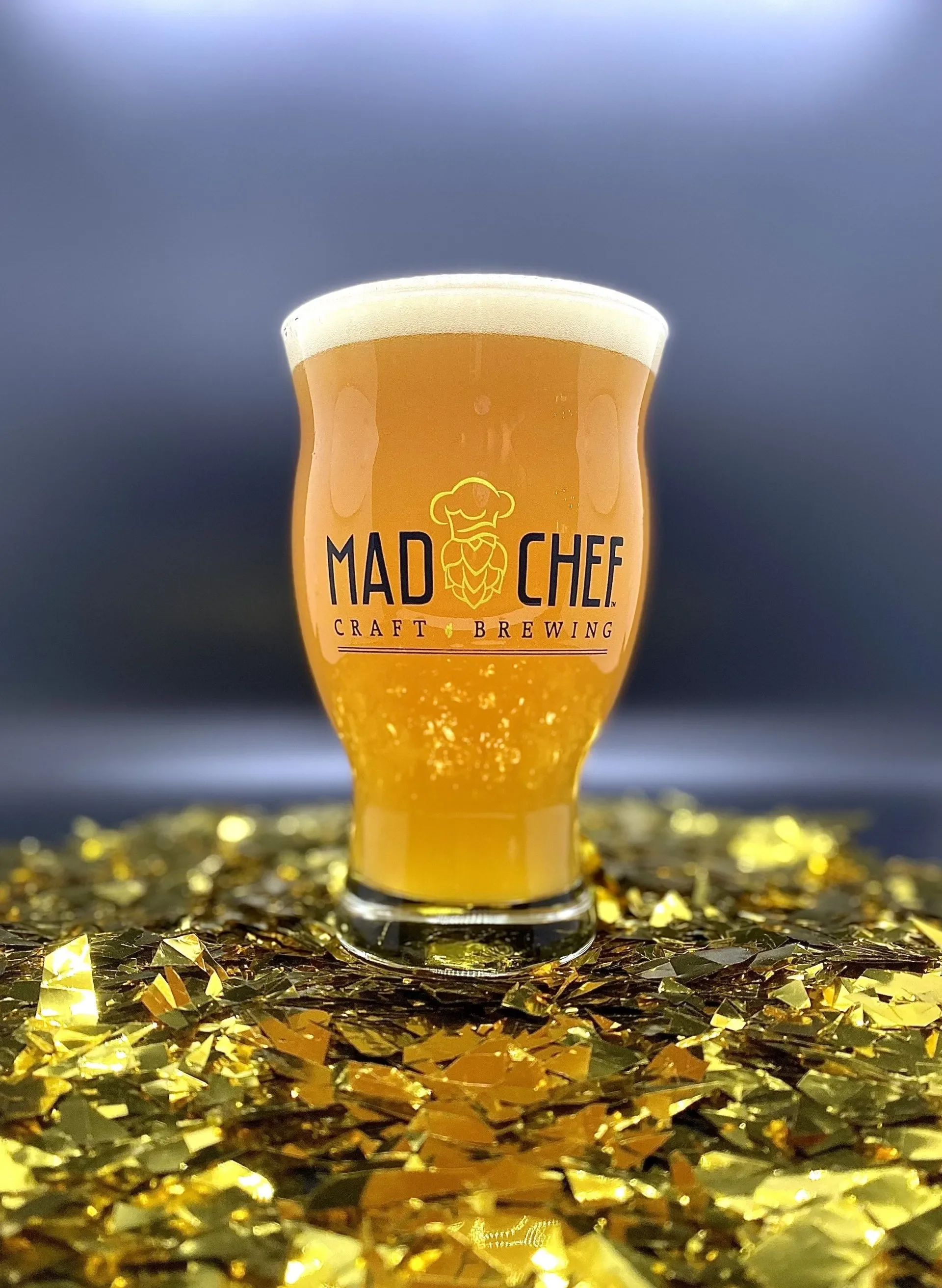 Craft beer in a glass with golden decor