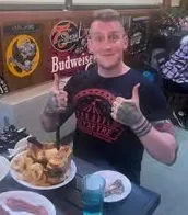 Happy diner enjoying a platter of fried seafood