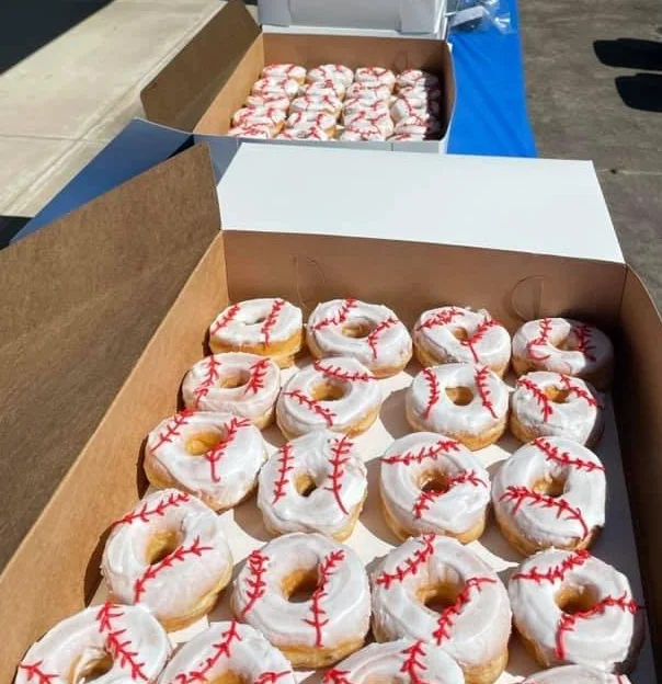 Baseball-themed donuts in a festive outdoor setting