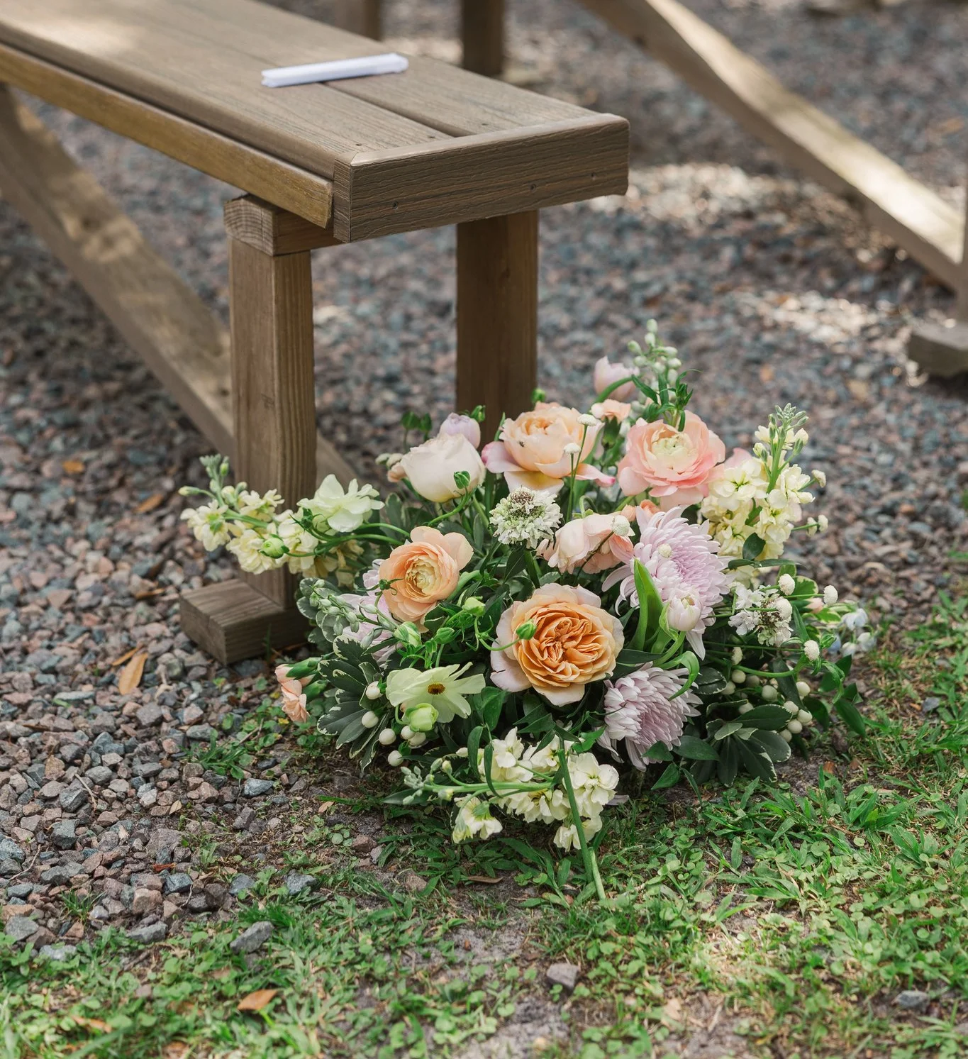 Beautiful floral arrangement at an outdoor wedding ceremony