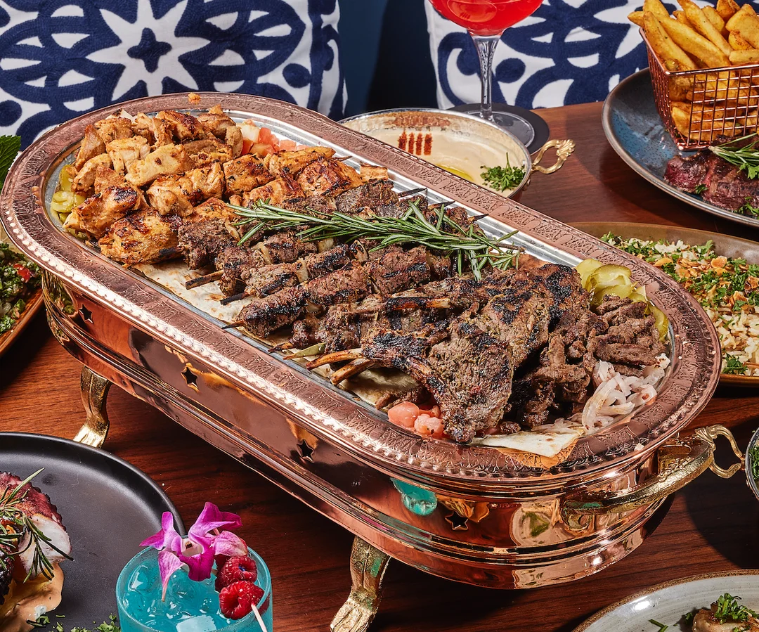 Sufrat Combo with basmati rice, chicken kebab skewers, beef kebab skewers, and more